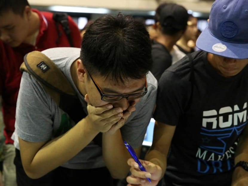 A student reacts to the release of his A-Level results at Hwa Chong Institution on Feb 23, 2018. Photo: Nuria Ling/TODAY