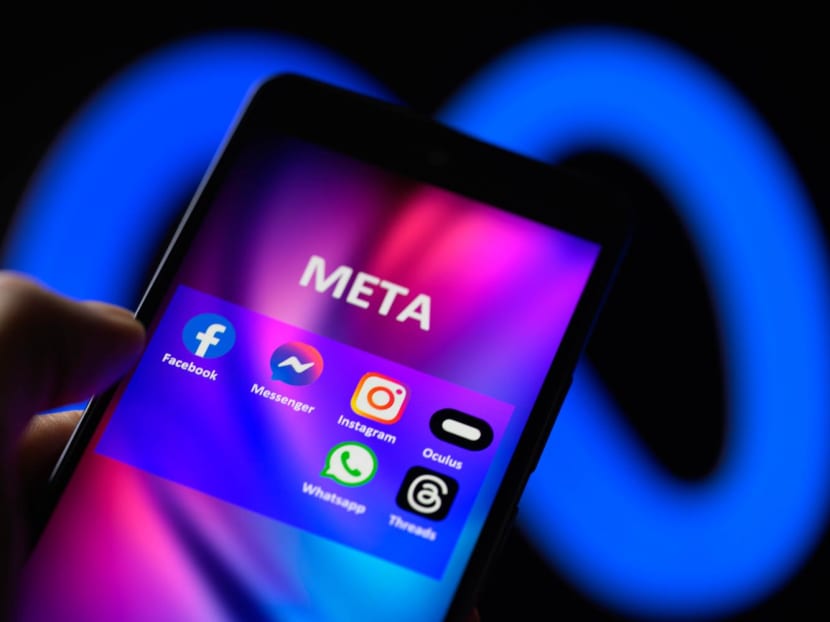 Meta social media icons displayed on a smartphone.