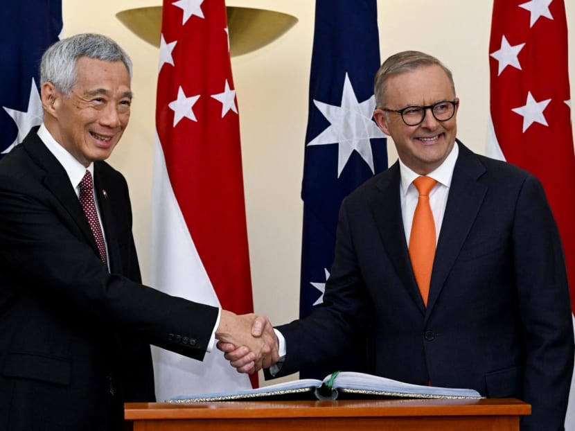 Australia's Prime Minister Anthony Albanese (right) shakes hands with Singapore's Prime Minister Lee Hsien Loong (left) during their meeting at Parliament House in Canberra on Oct 18, 2022.