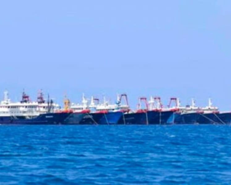 China denies incursion as more than 200 ships dock at Philippine reef