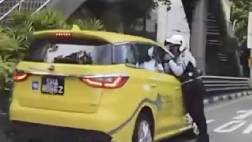 Taxi driver, 69, arrested for closing window on traffic cop's arm, dragging him along the road for several metres