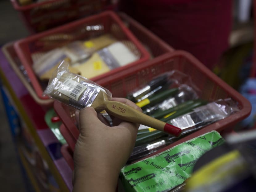 A Domestic Trade, Co-operatives and Consumerism officer is checking on the paint brushes that are believed the brushes are made from pig bristles at a hardware store outside Kuala Lumpur, Malaysia on Feb 8, 2017. Photo: AP