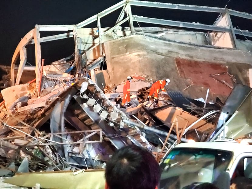 Rescue workers are seen on the site where a hotel being used for the novel coronavirus quarantine collapsed in the southeast Chinese port city of Quanzhou, Fujian province, China, on March 7, 2020.