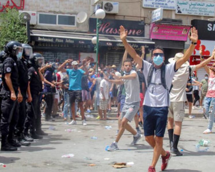 Tunisian president fires premier after violent protests