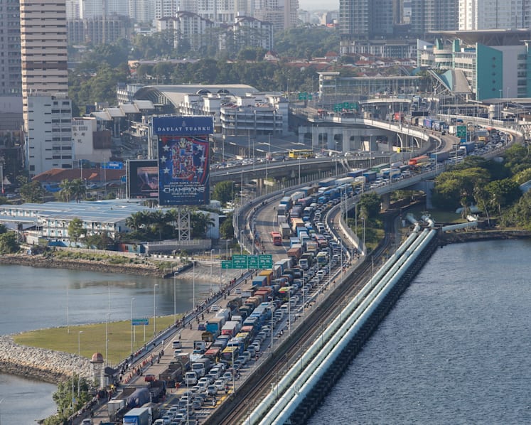 Flow of goods, cargo and food supplies between S’pore and M’sia to continue during M’sian lockdown: PM Lee