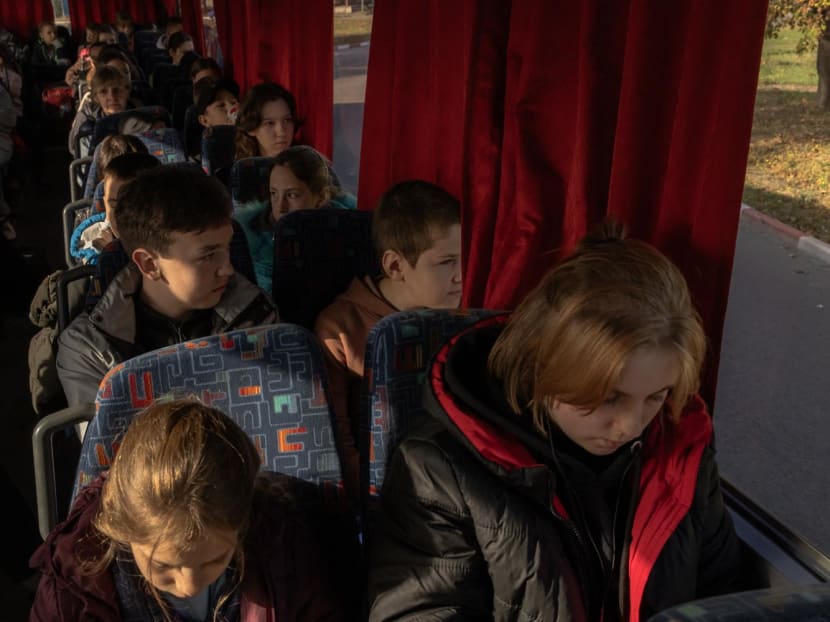 Children ride on a bus during their evacuation to western Ukraine, from the southern city of Kherson, on Oct 30, 2023, amid the Russian invasion of Ukraine.