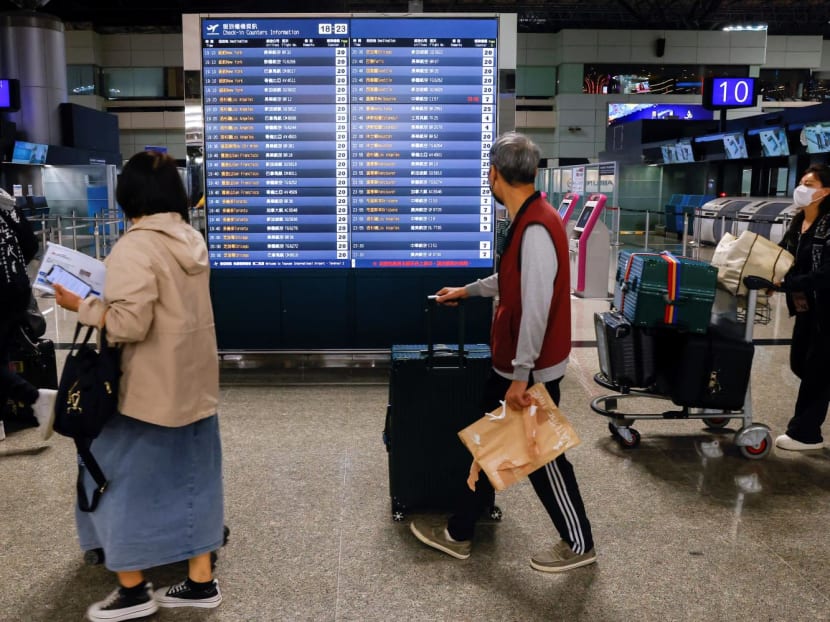 People look at flight information at Taiwan Taoyuan International Airport in Taoyuan, Taiwan on April 12, 2023.