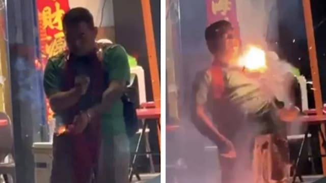 为招徕顾客 马国烟火业者把鞭炮挂脖子点燃