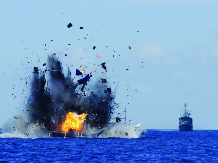 The Indonesian Navy destroys foreign fishing vessels caught fishing illegally in waters near North Sulawesi yesterday. Photo: REUTERS
