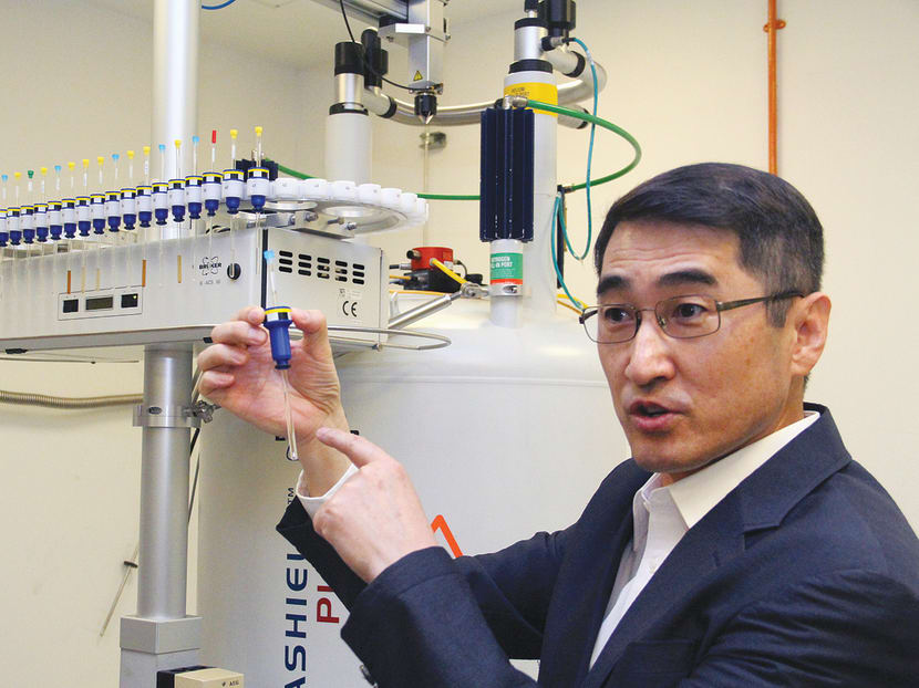 Associate Professor at the Nanyang Technological University (NTU) School of Biological Sciences Yoon Ho Sup with a protein sample, which will then be inserted into a Nuclear Magnetic Resonance (NMR) spectroscopy machine to identify the compounds which could bind and activate Nurr1 in the brain. Photo: Jaslin Goh