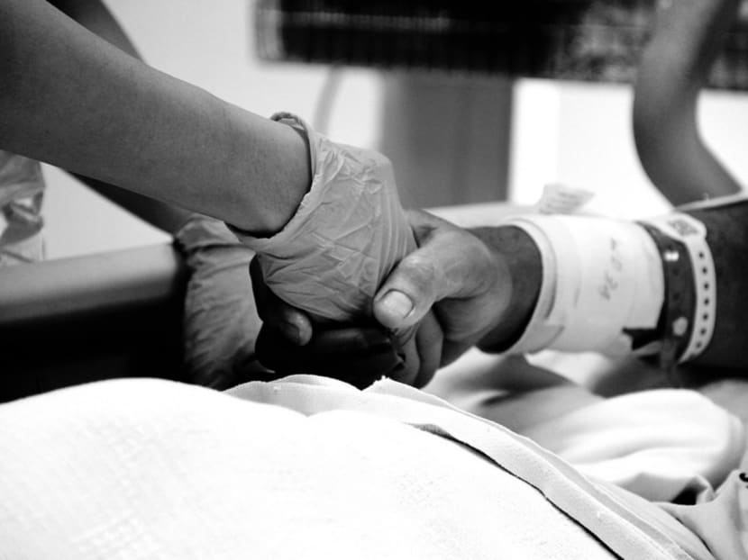 A tender moment in the NICU at Tan Tock Seng hospital between a patient and a senior nurse . TODAY file photo