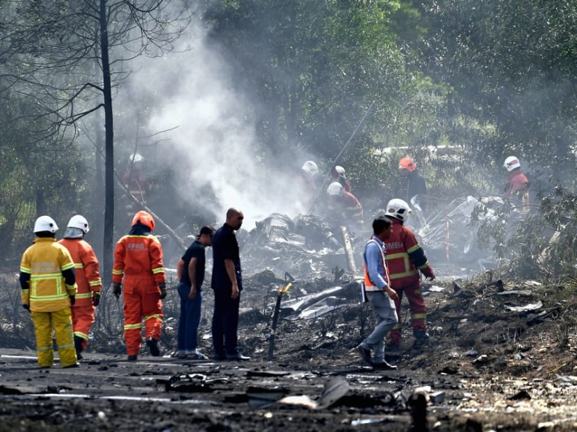Personnel from a fire and rescue department putting out the fire at the site of the crash in Bandar Elmina, Shah Alam, Aug 17, 2023.