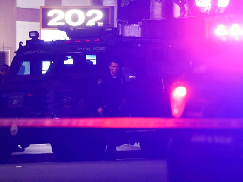 A police officer stands outside an office building where four people, including a child, were killed in a shooting on March 31, 2021 in Orange, California. Police shot and wounded a suspect in the shooting who was transported to a local hospital.