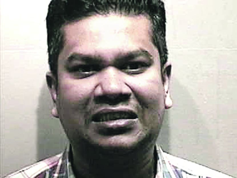 Ansari and his two accomplices wore police uniforms to deceive their victims. Photo: SPF