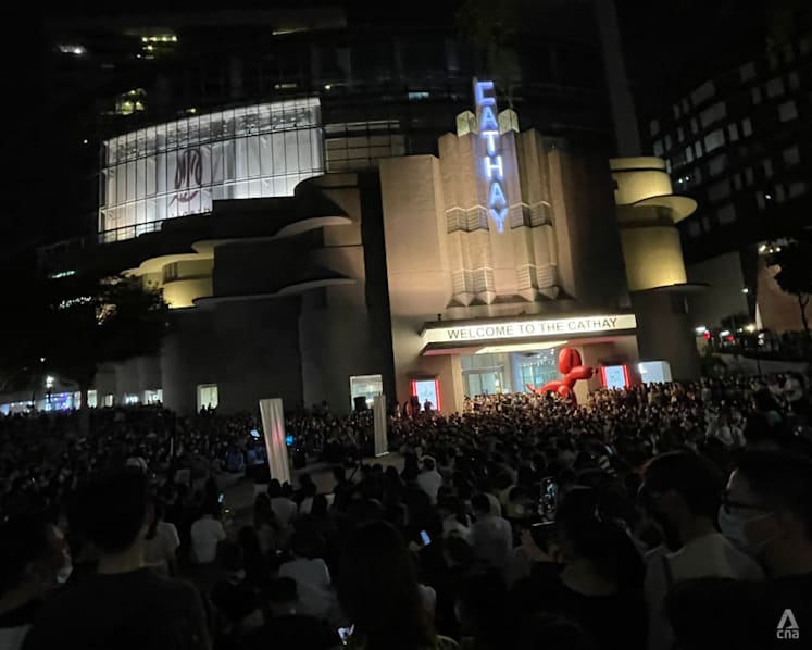 Large crowds outside The Cathay as people gather to watch busker perform