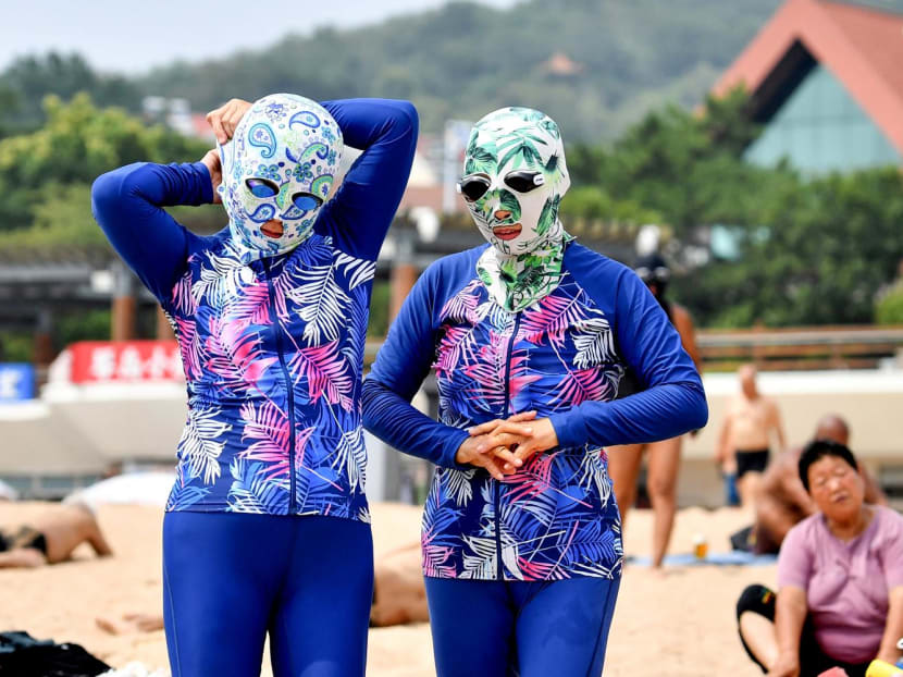 The 'facekini', a full-face mask that shields the wearer from harmful UV rays, is the latest fashion trend in China amid soaring temperatures hitting 40°C. The 'facekini', a full-face mask that shields the wearer from harmful UV rays, is the latest fashion trend in China amid soaring temperatures hitting 40°C.
