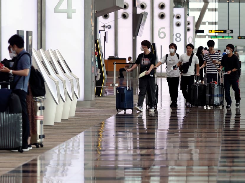 People wearing masks walk in Changi Airport following the coronavirus outbreak in Singapore, March 5, 2020. People wearing masks walk in Changi Airport following the coronavirus outbreak in Singapore, March 5, 2020.