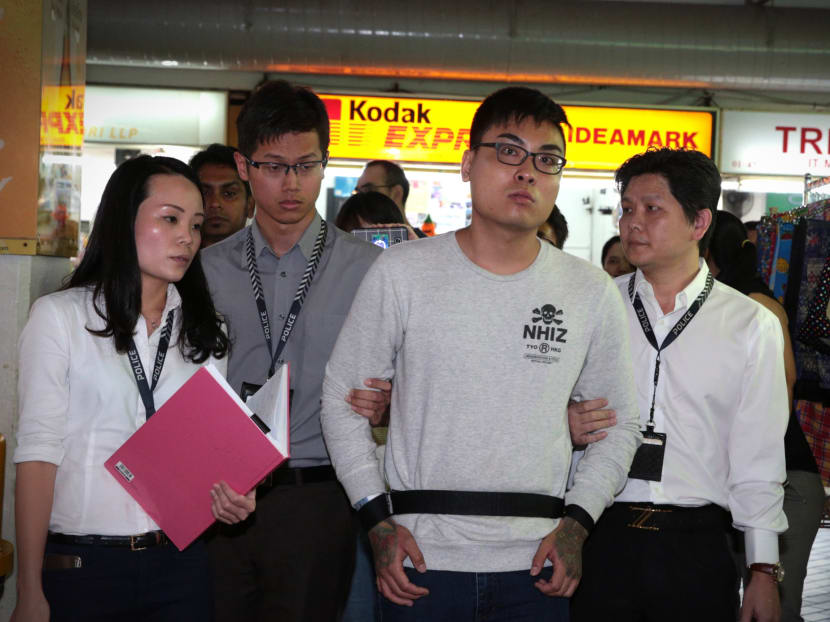 The suspect for the Golden Mile Complex assault was brought to the scene for an reenactment on Sunday (Oct 15). He will be charged on Monday. Photo: Jason Quah/TODAY