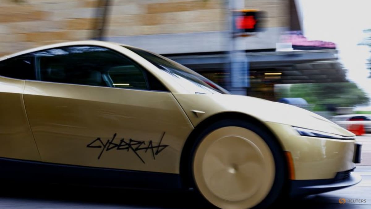 A gold-colored Tesla Cybercab arrives for an event in downtown Austin, Texas, U.S., September 3, 2026. Picture taken with a slow shutter speed. REUTERS/Kaylee Greenlee