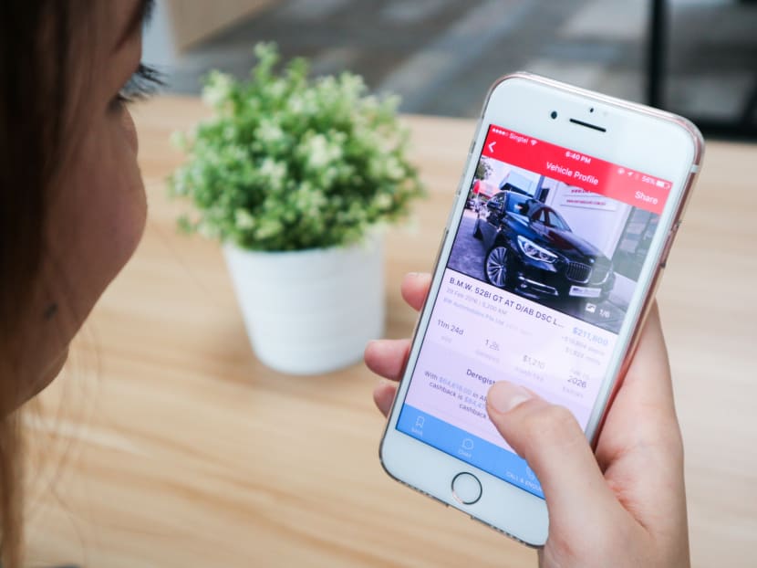 Photo illustration of a woman using the Carousell Motors app. Photo: Carousell
