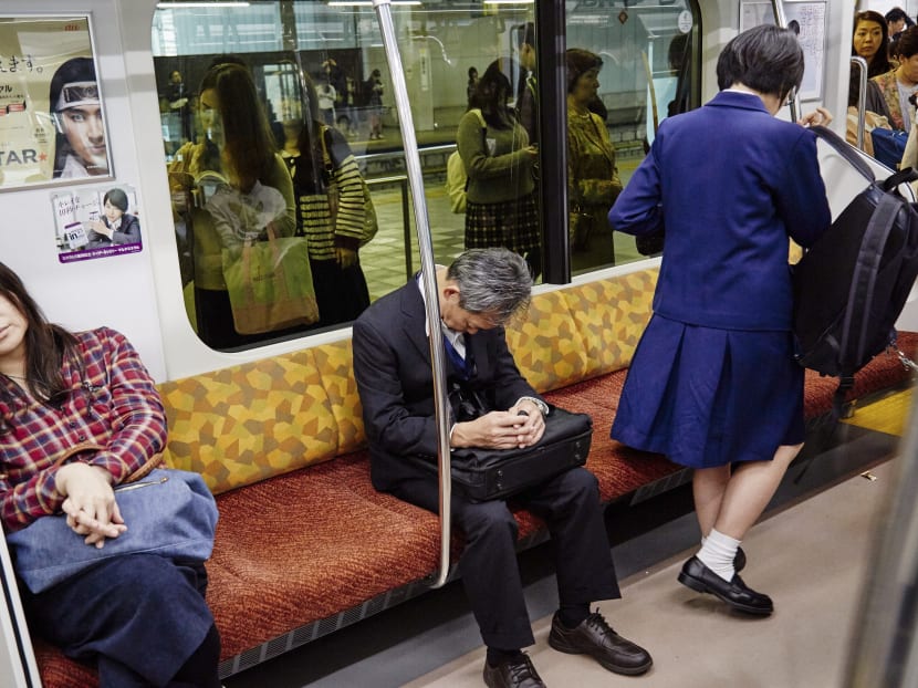 Commuters sleeping on a train in Tokyo on Oct 21, 2016. “Inemuri” or “sleeping while present” is common practise in Japanese stores, subways and offices, where it is often seen as a subtle sign of diligence. Photo: The New York Times