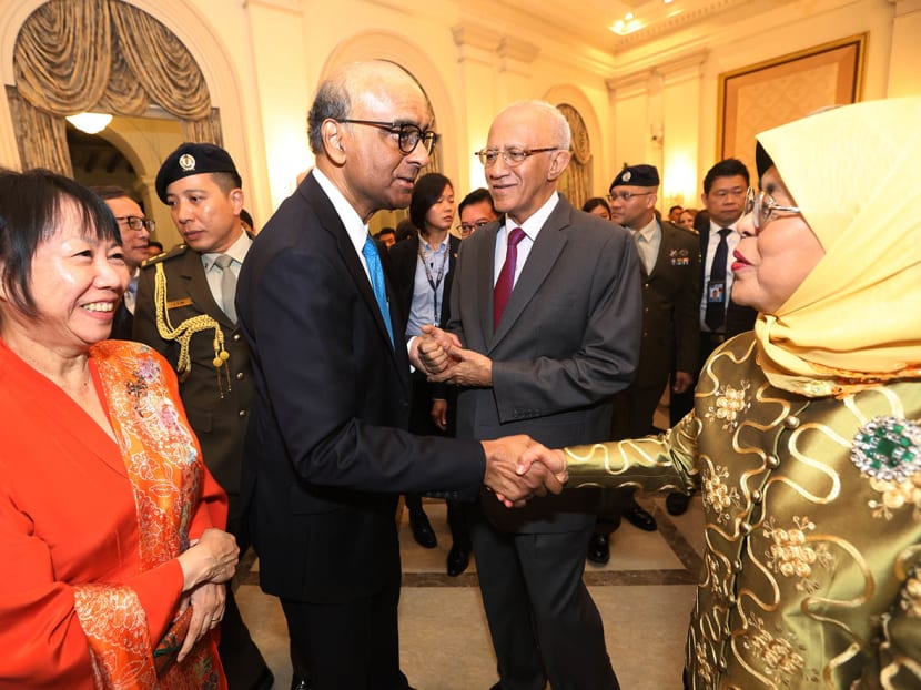 President Halimah Yacob shaking hands with President-elect Tharman Shanmugaratnam during a farewell reception at the Istana on Sept 13, 2023. 