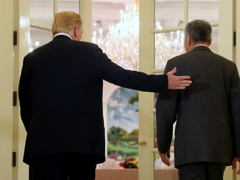 US President Donald Trump gestures beside Prime Minister Lee Hsien Loong at the Istana on Monday (June 11), a day ahead of his historic meeting with North Korean leader Kim Jong-un.