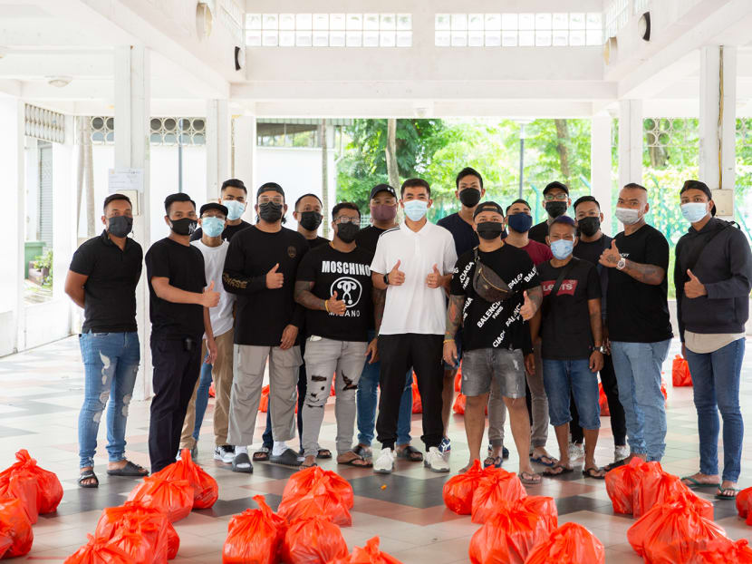 A group of volunteers, including ex-convicts, during a charity event at North Bridge Road on April 17, 2022.