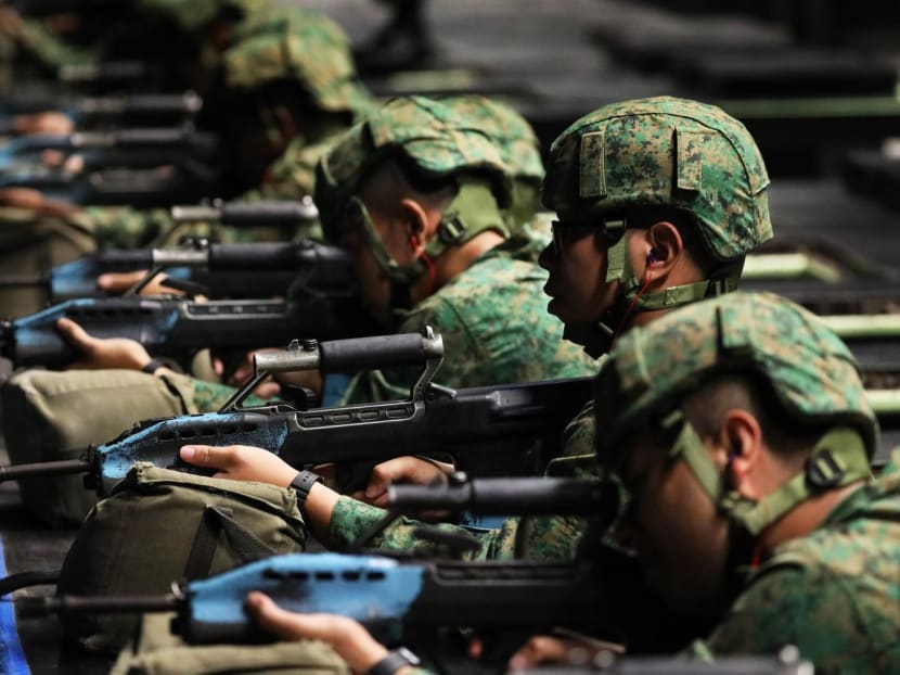 Recruits at an indoor shooting range in Pulau Tekong on June 29, 2021. Recruits at an indoor shooting range in Pulau Tekong on June 29, 2021.