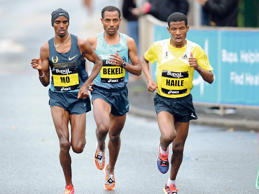 Gebrselassie (right) racing with current Olympic champion Mo Farah (left) during the Great North Run in England last year. Gebrselassie is taking part in this year’s Standard Chartered Marathon. Photo: Getty Images