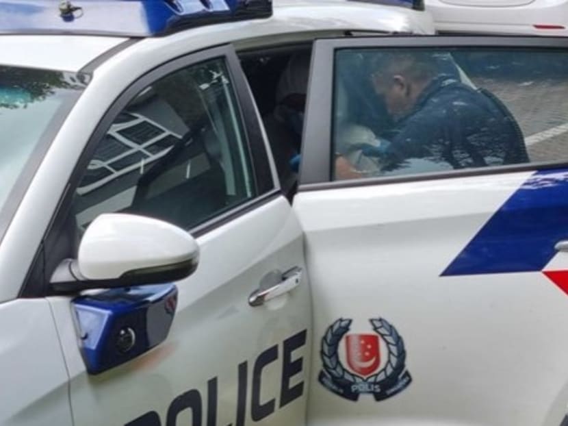 Police escorting the suspect at Block 460B Bukit Batok West Avenue 9 on Jan 6, 2024. 

