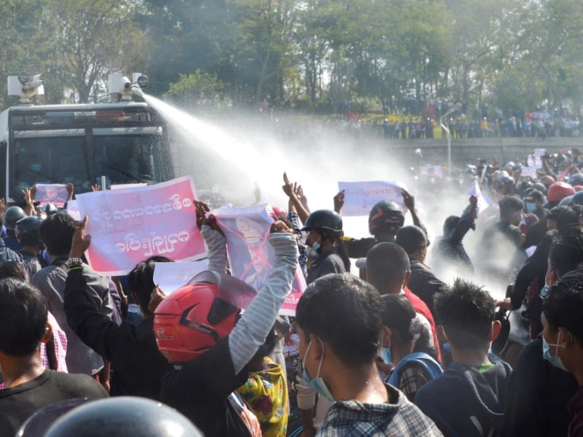 A police vehicle fires water cannon in an attempt to disperse protesters during a demonstration against the military coup in Naypyidaw on Feb 8, 2021