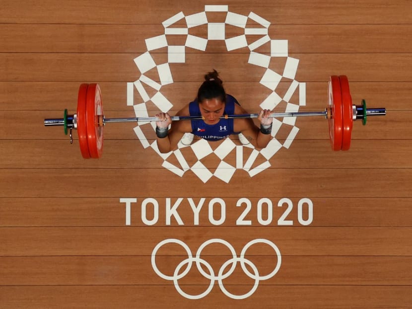 An overview shows Philippines' Hidilyn Diaz competing in the women's 55kg weightlifting competition during the Tokyo 2020 Olympic Games at the Tokyo International Forum in Tokyo on July 26, 2021.