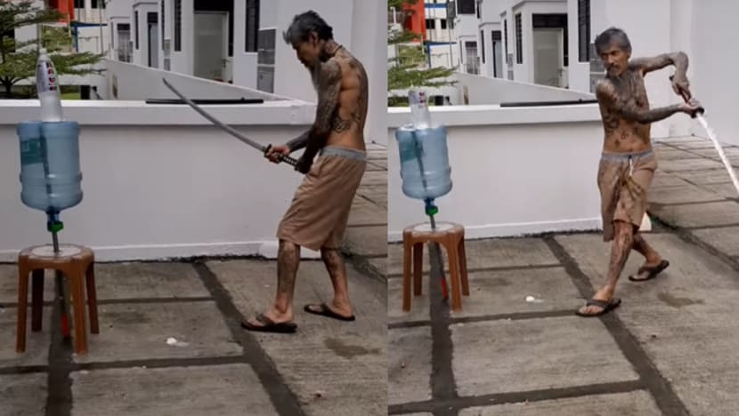 Man who posted video of himself slicing bottle with samurai sword charged