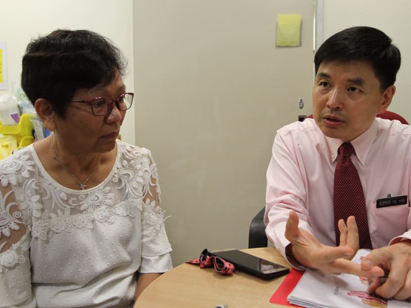 Mdm Teo Kim Geok, 60, with Associate Professor Han How Chuan, Head and Senior Consultant at the Department of Urogynaecology in KK Women's and Children's Hospital, discussing her now treated pelvic organ prolapse condition.
