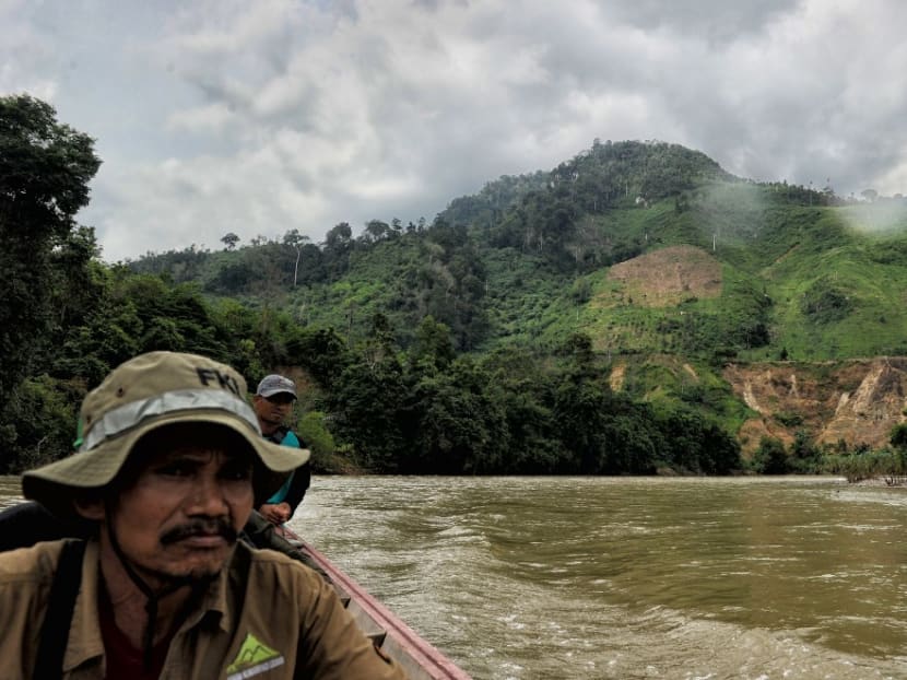 This file photo taken on May 7, 2017 shows a team of Indonesian forest rangers making their way along the Alas river, as signs of deforestation from illegal logging are seen in the background, in the Leuser ecosystem rainforest, located mostly within the province of Aceh on the northern tip of the island of Sumatra.