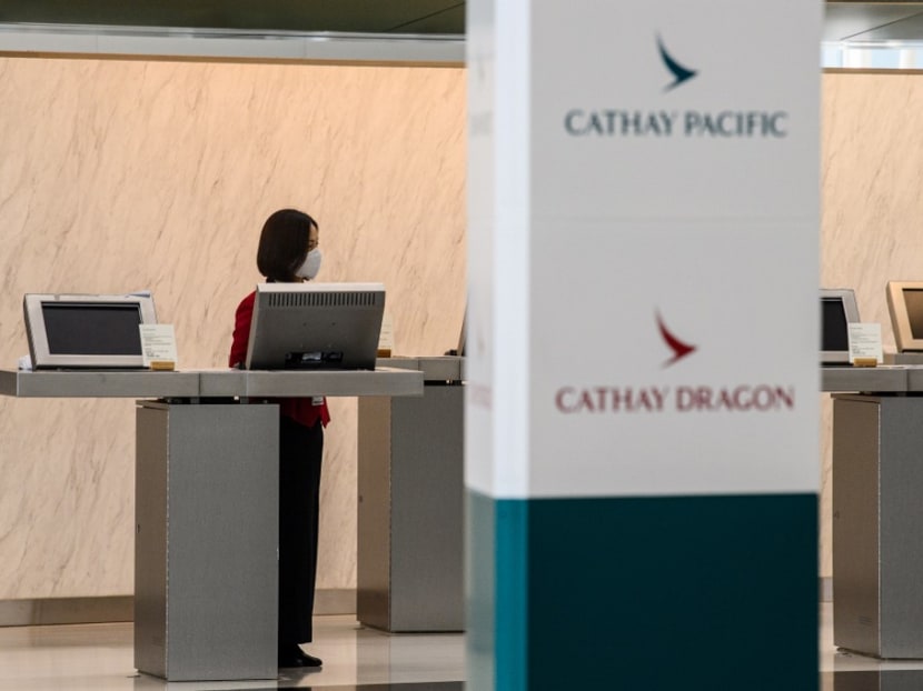 An employee waits for customers at a counter for Cathay Pacific and Cathay Dragon at Hong Kong International Airport on Oct 20, 2020.