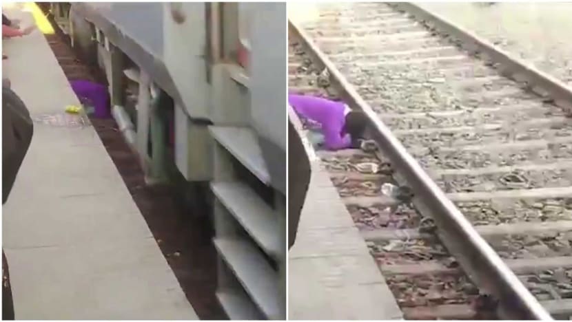 Woman in India shields her children from moving train after falling onto track; all three survive Woman in India shields her children from moving train after falling onto track; all three survive