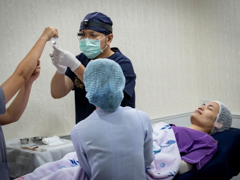 Thai surgeon Sakirin Al-Ishak prepares an anaesthetic injection during a plastic surgery on a patient in Vayo Clinic, in Bangkok on Nov 11, 2020. Thai surgeon Sakirin Al-Ishak prepares an anaesthetic injection during a plastic surgery on a patient in Vayo Clinic, in Bangkok on Nov 11, 2020.