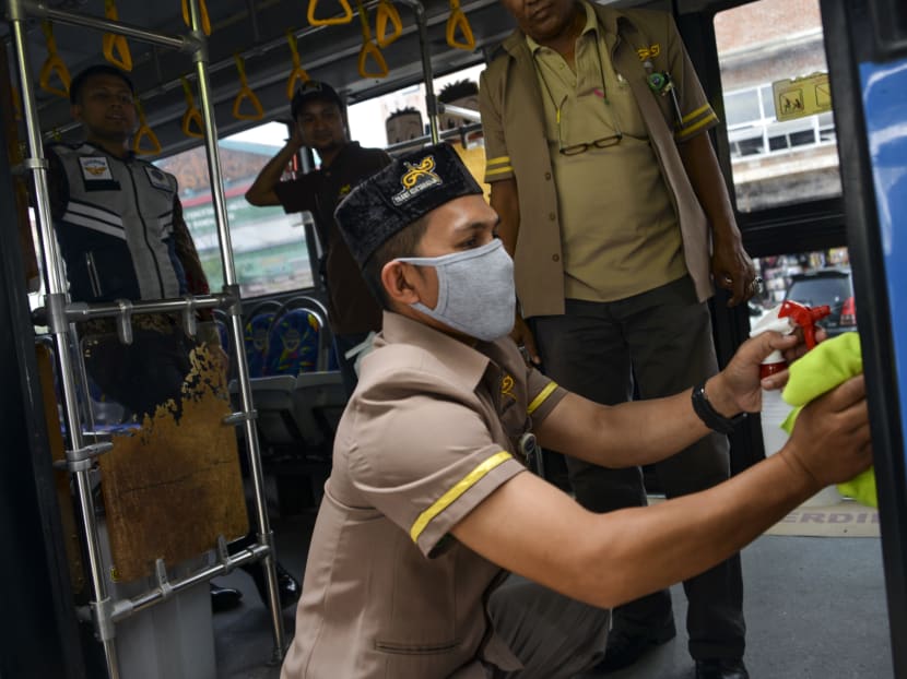 A worker sprays disinfectant on a bus as part of preventive measures against the spread of the Covid-19 coronavirus, in Banda Aceh on March 5, 2020. A worker sprays disinfectant on a bus as part of preventive measures against the spread of the Covid-19 coronavirus, in Banda Aceh on March 5, 2020.