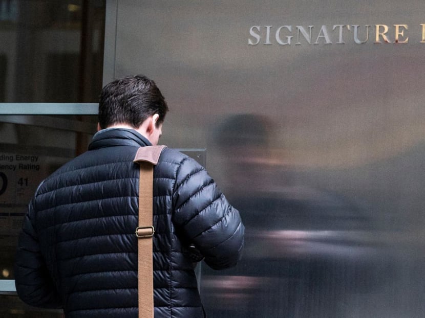 A worker arrives to the Signature Bank headquarters in New York City, US, March 12, 2023.