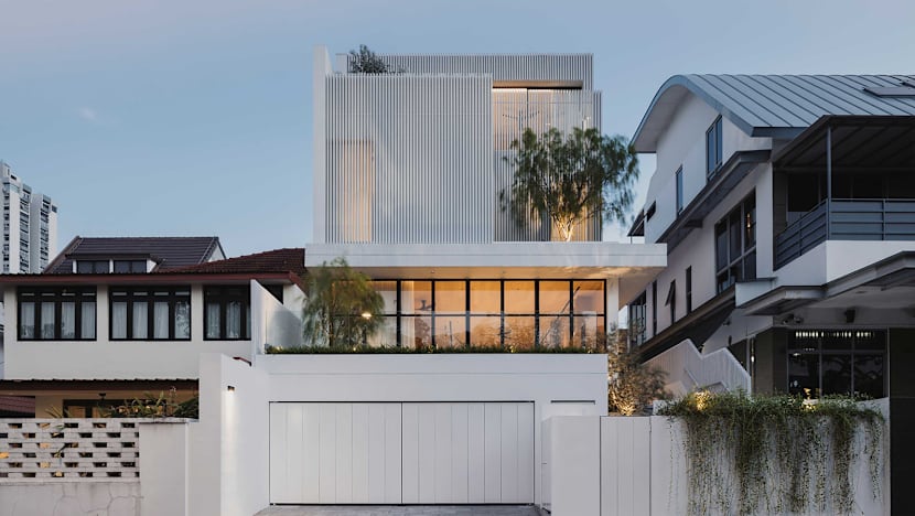 Behind the mysterious white facade of this Singapore semi-detached house lies a warm, light-filled home