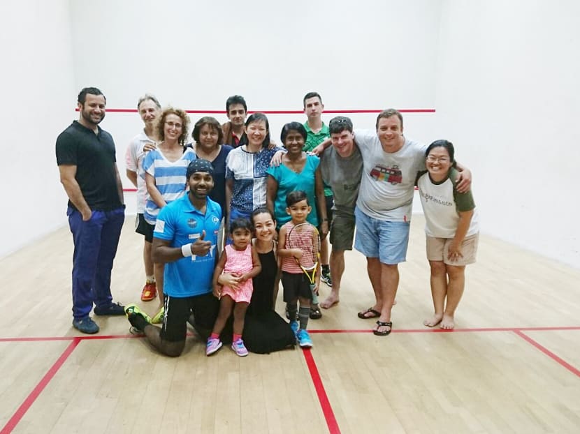 Members of Singapore Cricket Club’s squash section helped raise S$1,350 for Singapore professional squash player Vivian Rhamanan (centre) at a fundraising event on Saturday. Photo: Singapore Cricket Club