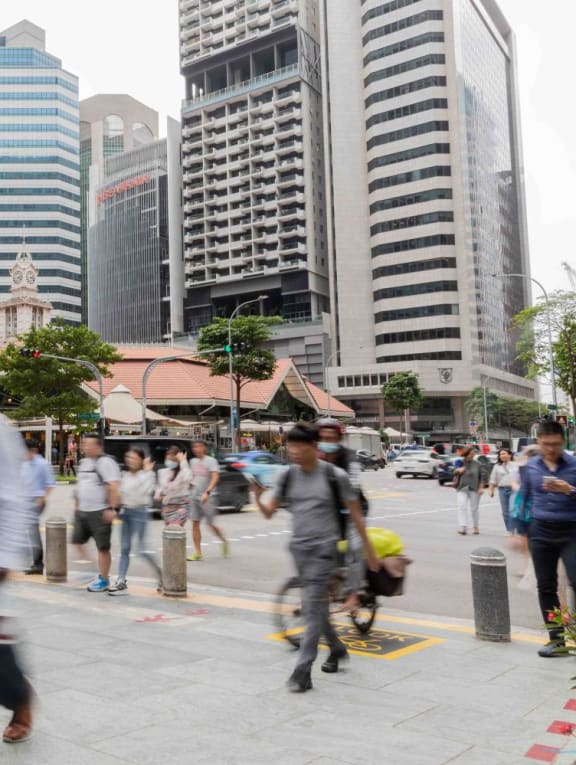 People walking in the Central Business District in Singapore on March 15, 2023.