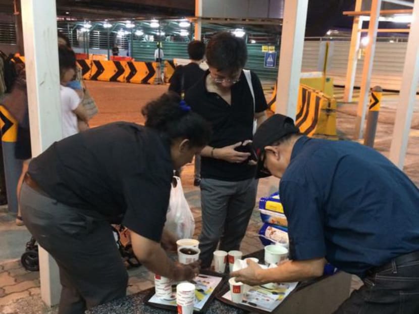 McDonald's staff serving drinks to people affected by the SMRT train disruption. Photo: @lilyjamesgrey/Twitter