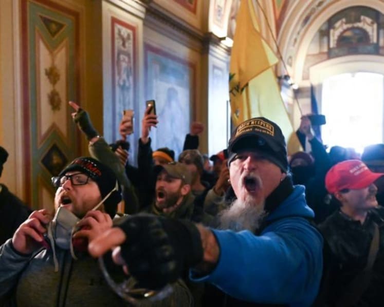 Guns and tear gas in US Capitol as Trump supporters attempt to overturn his loss