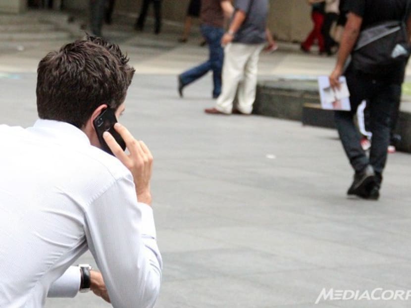 A man uses his phone in the central business district in Singapore. Photo: Channel NewsAsia