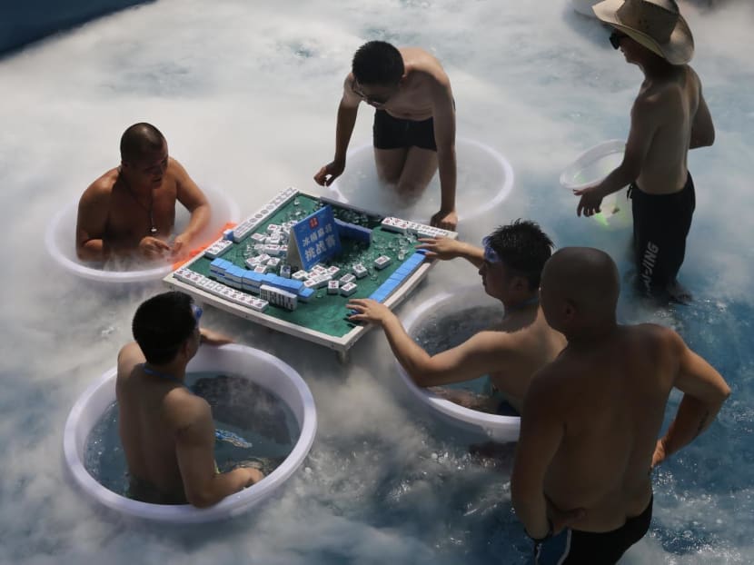 #trending: Chongqing residents chill in supermarket air-con, play mahjong in iced water amid record heatwave