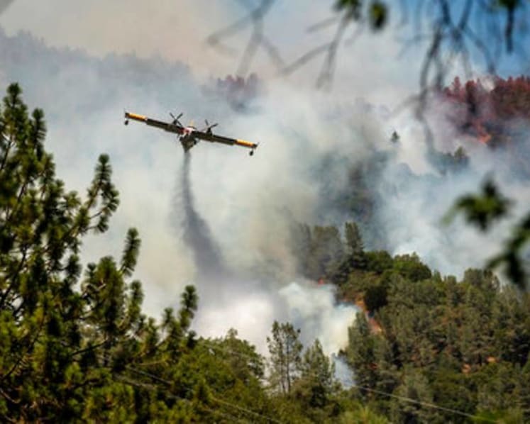 California firefighters battle big wildfires in high heat