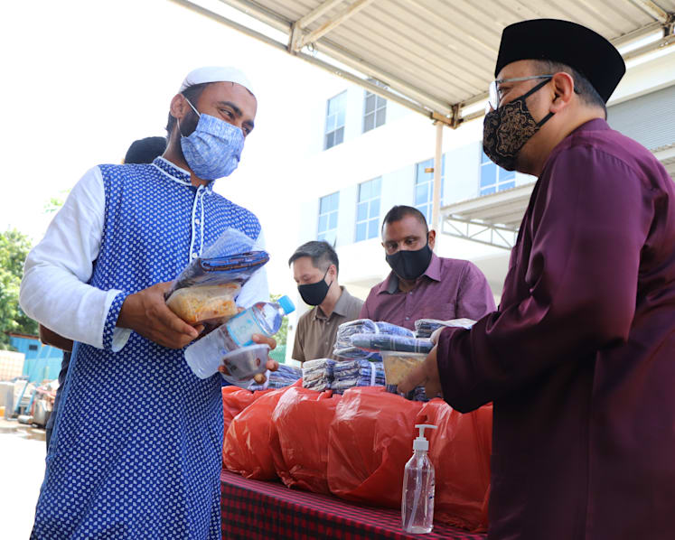 Volunteer groups distribute food, gifts to migrant workers confined in dorms to spread Hari Raya cheer